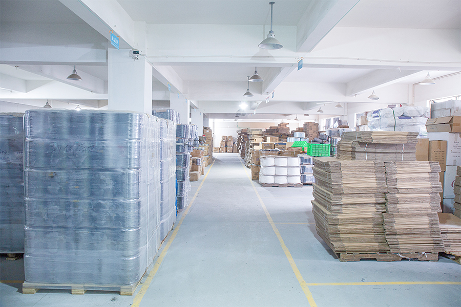 Palletized packing materials staged in the warehouse aisle